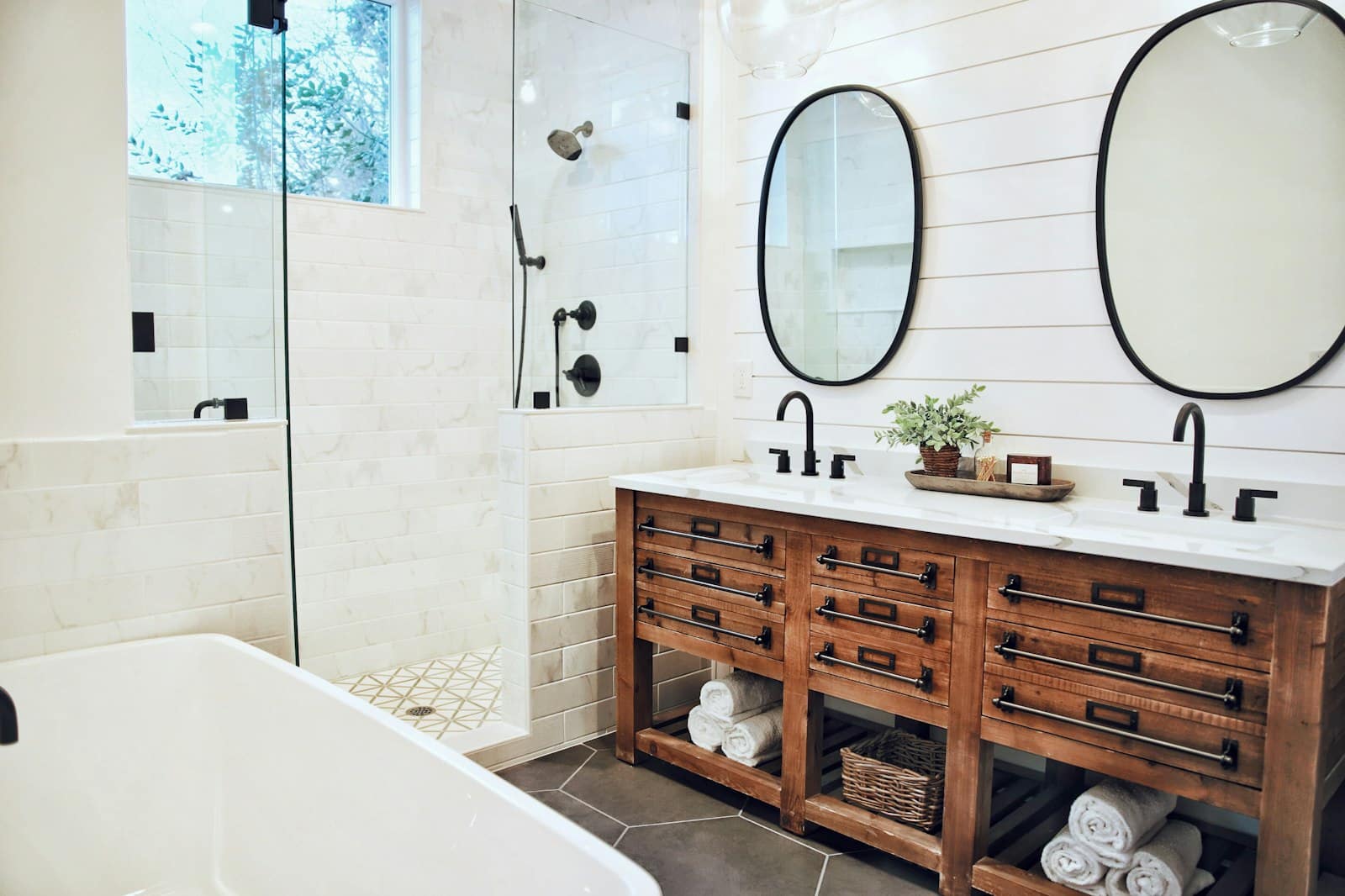 Country modern bathroom in Cle Elum with warm wood tones and ceramic bathtub