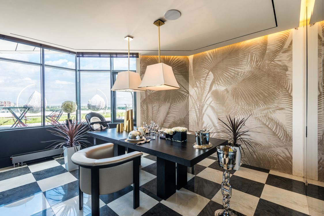 Moody dining room with dramatic wallpaper and warm ambient lighting